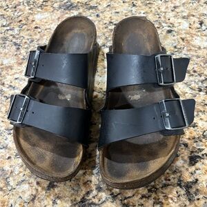 Worn black Arizona Birkenstock leather sandals